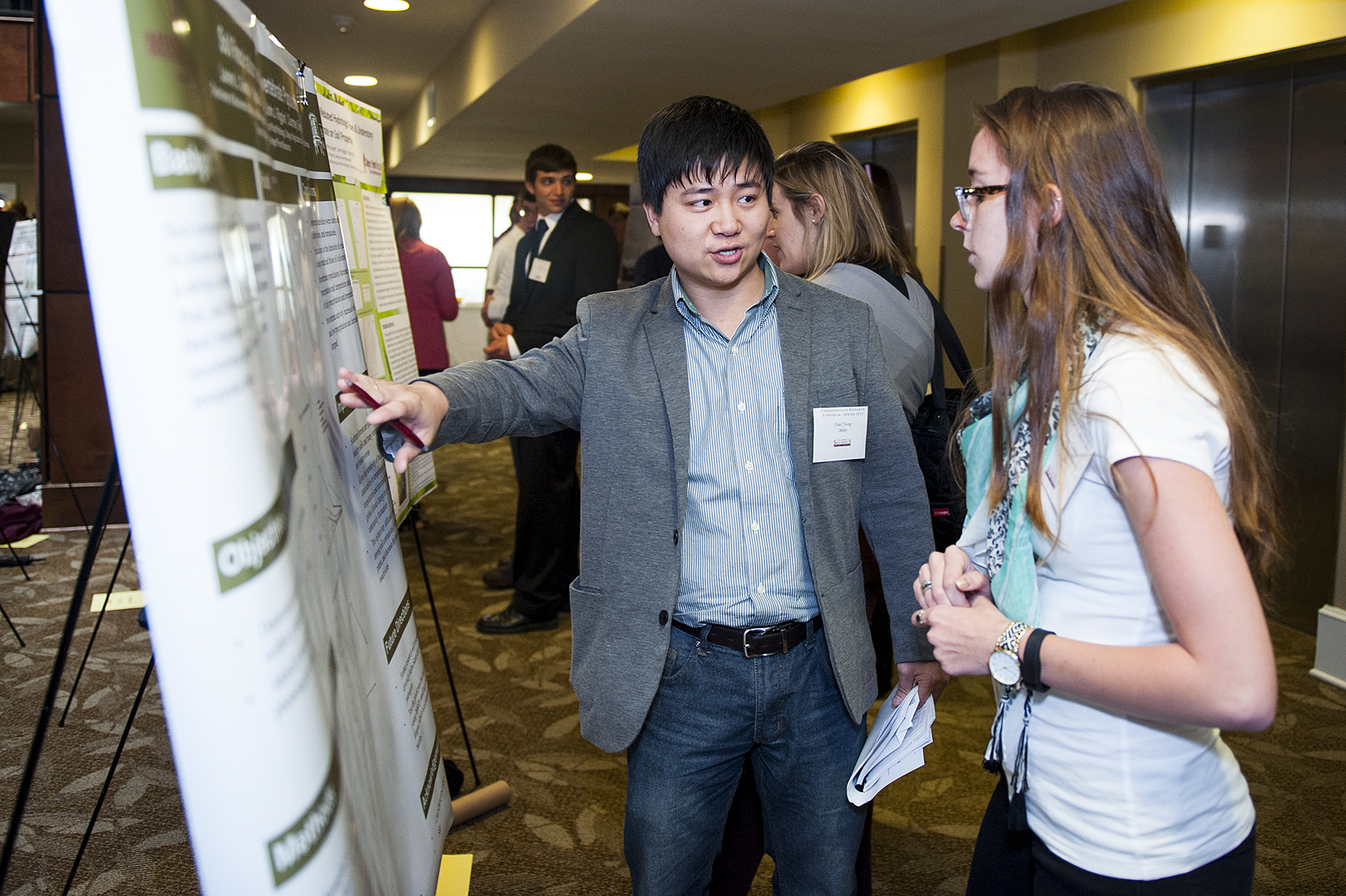 Sophomore Lauren L. Gamblin, a horticulture/floriculture and ornamental major of Akron, Ohio, discusses her project with Te-Ming "Paul" Tseng, assistant professor of plant and soil sciences, during MSU's 2015 Undergraduate Research Symposium.