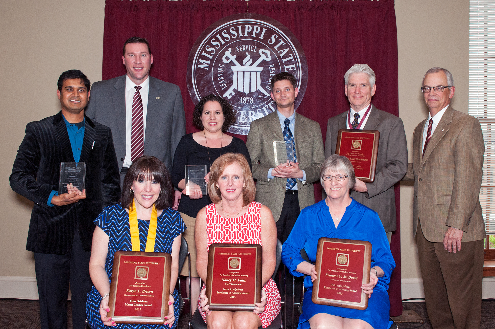 MSU's 2014-15 faculty award honorees include (seated, from left) Karyn Brown, Nancy Fultz, and Frances McDavid, (standing, from left) Veera Gude, Lindsey Peterson, Jared Keeley, and Brent Funderburk. The honors were presented by MSU Alumni Association Executive Director Jeff Davis (standing, second from left) and Provost and Executive Vice President Jerry Gilbert (at far right).