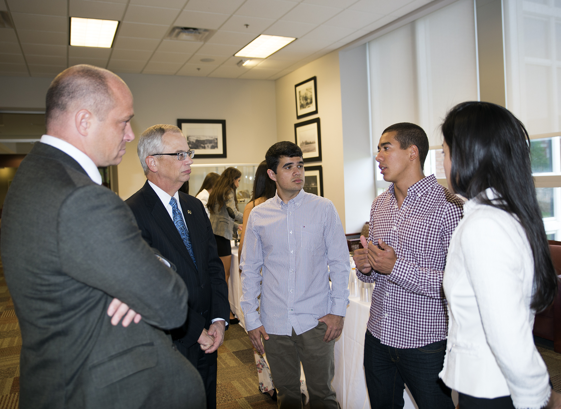 From left, Interim Associate Vice President of International Programs Jon Rezek and Provost and Executive Vice President Jerry Gilbert visit with Brazilian exchange students Jose Vinicius Elias Gomes Galvao, Thiago Lima Prado, and Bruna Goncalves Aquino during a recent campus reception.