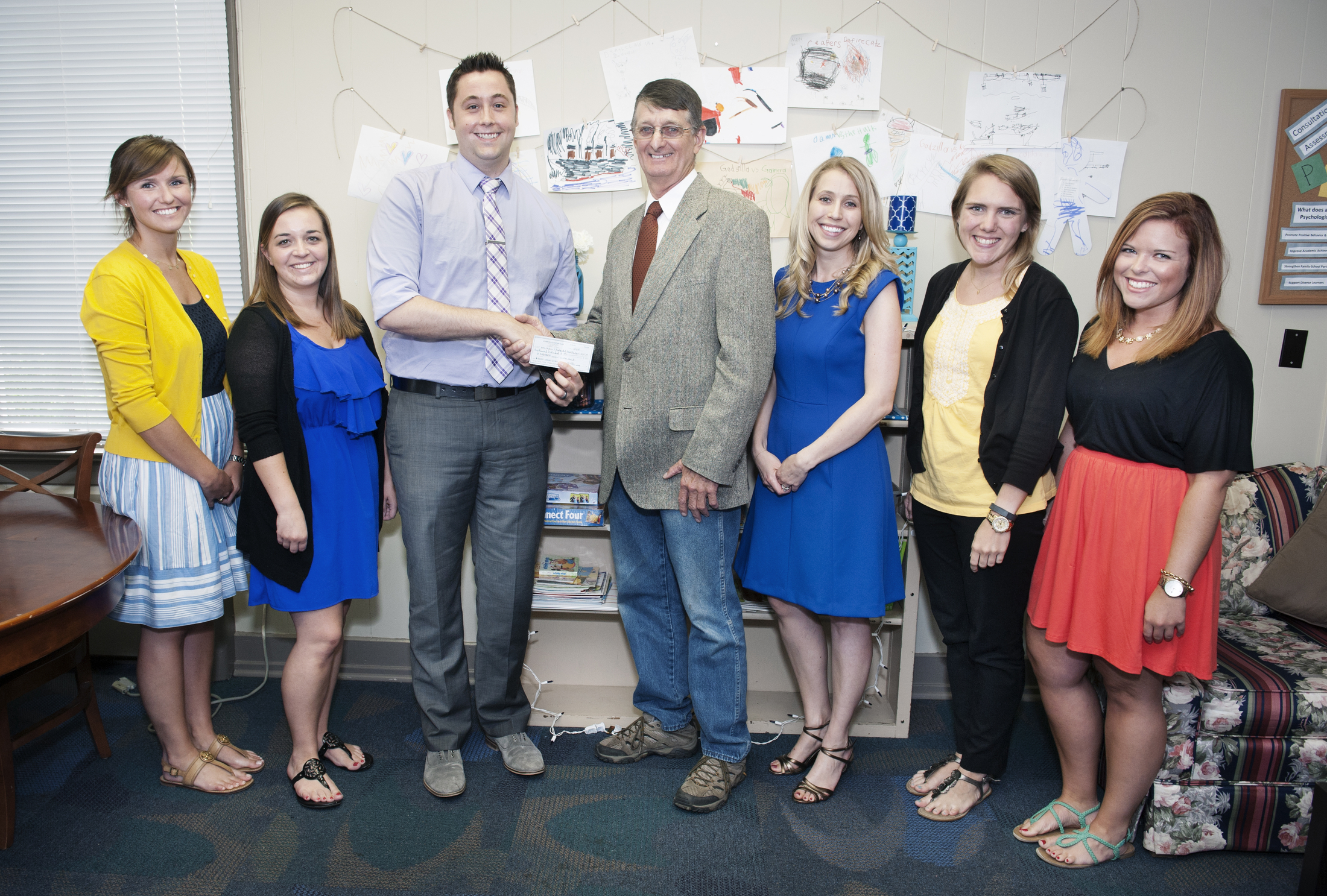 Receiving a donation from the Starkville Civitan Club represented by William Oakley, president, fourth from left, are (l-r) graduate assistants Mackenzie Sidwell and Hailey Ripple, assistant professor of counseling and educational psychology and director of the Autism and Developmental Disabilities Clinic Dan Gadke, assistant professor of counseling and educational psychology Kasee Stratton, and graduate assistants Molly Butts and Hallie Smith.