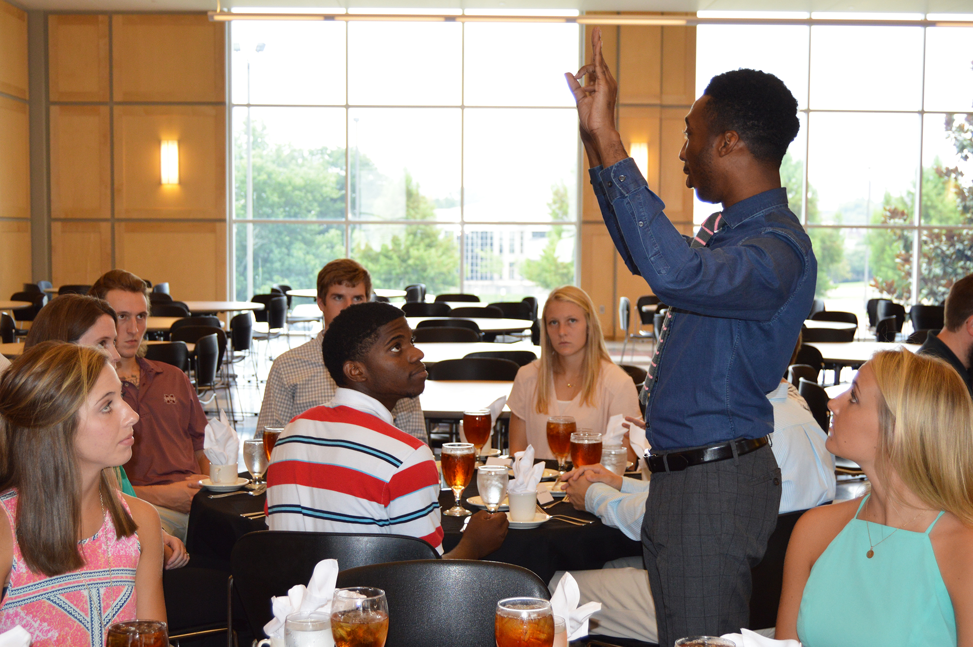 Ryan Colvin with MSU's Career Center speaks during the recent etiquette luncheon held as part of a summer life skills course. The event was designed to prepare students for future professional settings.