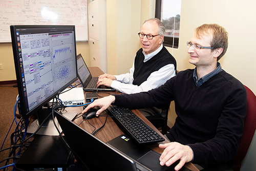 Robert Moorhead and Vuk Marojevic analyze data in Marojevic's office.