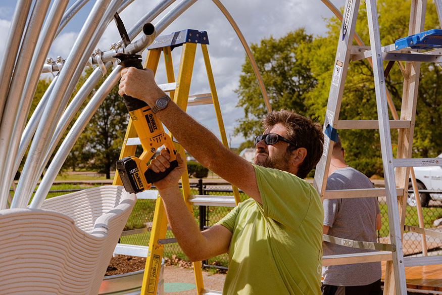 MSU Associate Professor Cory Gallo installs a trellis at the Galloway Elementary School garden in Jackson. 