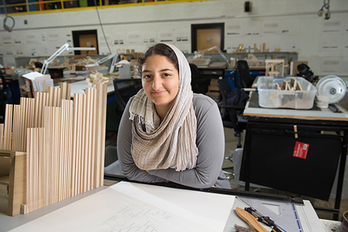 Portrait of Nada Abdel-Aziz pictured at work station in Giles Hall