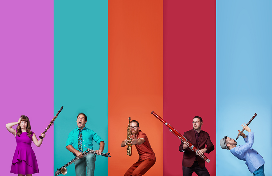 Akropolis Reed Quintet musicians are pictured in front of a purple, teal, orange, red and blue background.