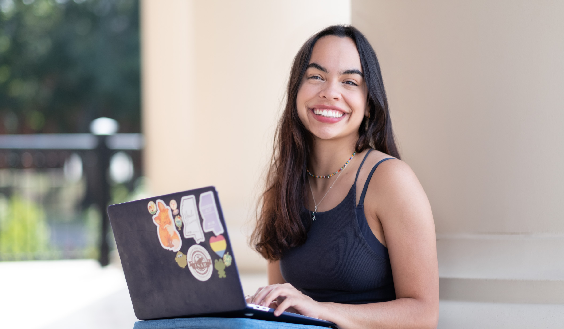 Laura Rios Alvarez, pictured outside with her laptop.