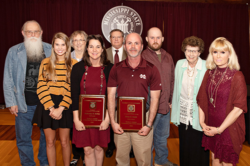 Katherine “Katy” Richey and Brian Smith, inaugural recipients of MSU’s Wesley A. Ammon New Academic Advisor Awards, center, are surrounded by members of Ammon’s family, (l-r) Ted Ammon, Abbie Ammon, Cherie Ammon Steele and Glenn Steele, Bret Ammon, Jean Woodruff and Jeannie Woodruff Ammon.  (Photo by Beth Wynn)