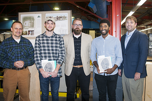 Mississippi State University senior architecture students Barnes Brown of Franklin, Tennessee, second from left, and Patrick T. Greene of Southaven, second from right, received first place for their forestry and wildlife outreach center master plan and building proposal. Congratulating them are (left) Rubin Shmulsky, head of the MSU College of Forest Resources’ Department of Sustainable Bioproducts; (center) MSU Assistant Professor Jacob A. “Jake” Gines; and (right) Mississippi Forestry Association Executive Vice President J. Tedrick Ratcliff Jr. (Photo by Allison Matthews)