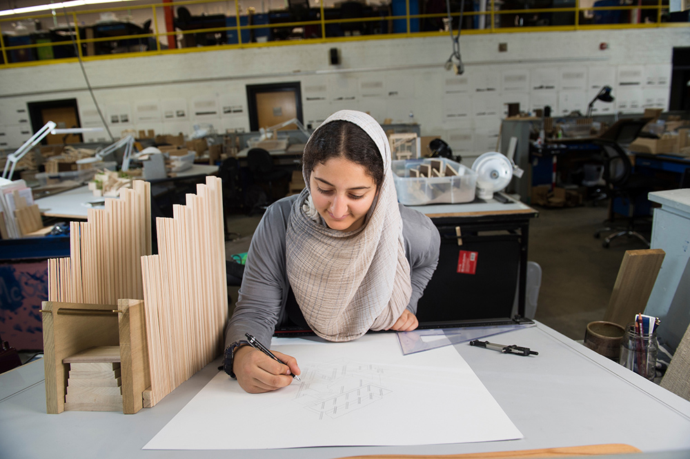 Architecture student Nada Abdel-Aziz is pictured at a work station in Giles Hall.