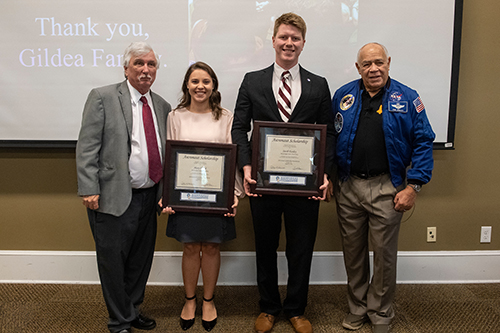 MSU alumnus Ray Gildea, 2019 Astronaut Scholars Mary Catherine Beard and Jacob Easley, and retired NASA astronaut Fred Gregory smile for a group photo.
