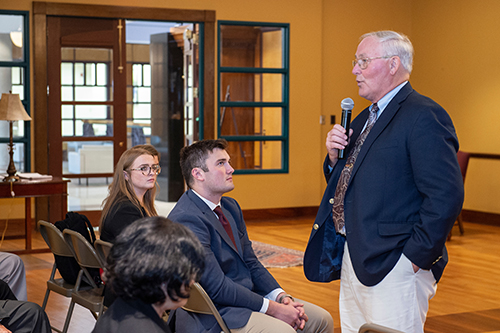 Emma Wade and Britain Steele listen to remarks by retired NASA Astronaut Jerry Ross. 