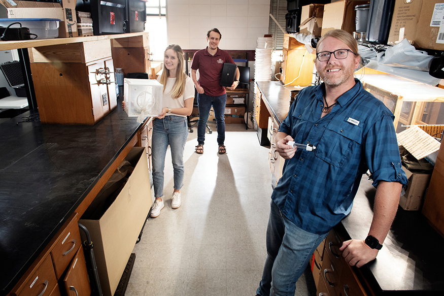 Brandon Barton pictured in a lab with his students