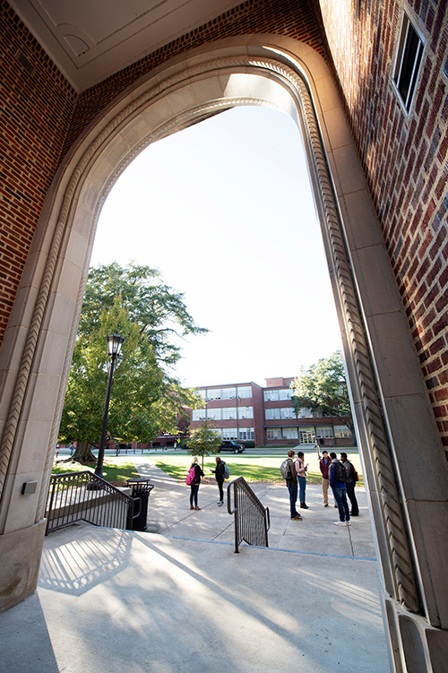 Students talk outside of Bowen Hall