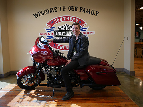 MSU senior communication/broadcasting major Brock St. Clair of Germantown, Tennessee, is all smiles aboard his new “Hard Candy Hot Rod Red Flake” Street Glide Special motorcycle. St. Clair is among eight students who are helping to tell Harley-Davidson’s stories as part of an eight-week “Find Your Freedom” summer internship experience. (Photo submitted)