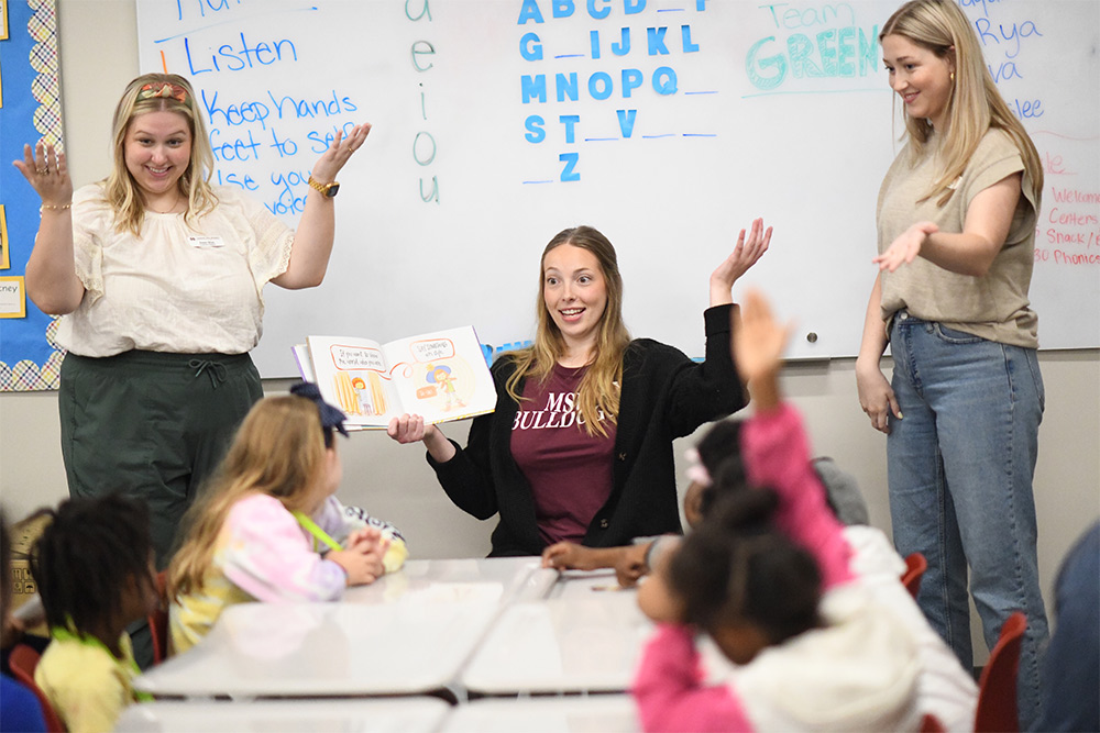 MSU graduate students lead young elementary students with reading activities