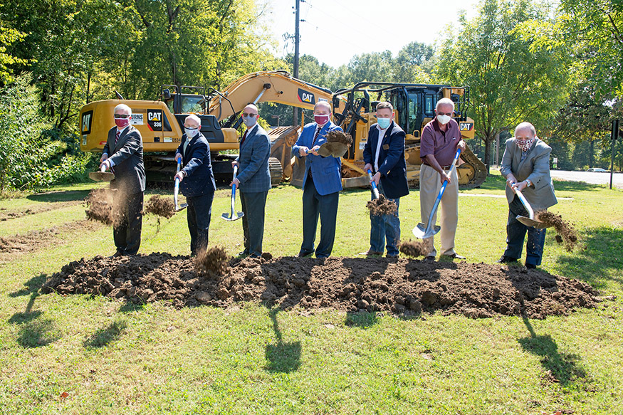 MSU personnel and others use shovels to break ground on Bulldog Way.