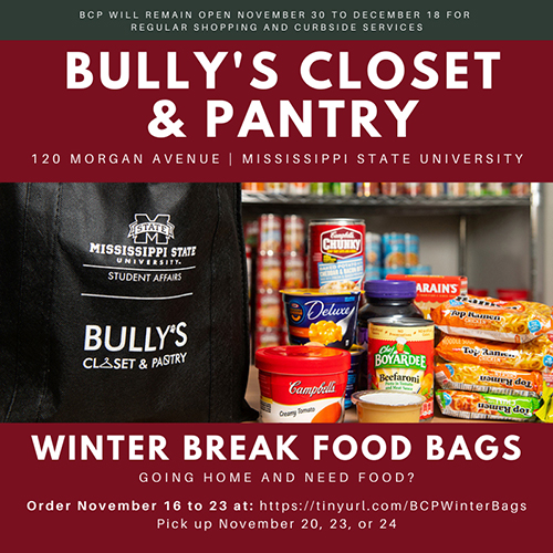 A black tote bag with MSU Student Affairs and Bully’s Closet and Pantry logos is pictured next to soup cans, applesauce, macaroni and cheese, jelly, rice and Ramen noodles