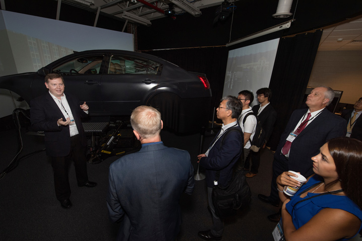 MSU Center for Advanced Vehicular Systems Associate Research Professor Daniel Carruth shows the center’s driving simulator to researchers during the International Symposium on Advanced Vehicle Technology. The symposium brought together researchers from France, Germany, Japan and South Korea. (Photo by Beth Wynn)