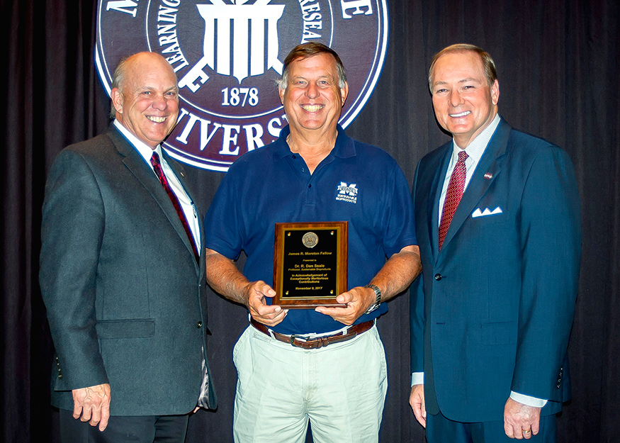 George Hopper, left, dean of MSU’s College of Forest Resources, and MSU President Mark E. Keenum, right, present Dan Seale with a plaque commemorating his designation as James R. Moreton Fellow during a recent CFR/FWRC advisory board luncheon and awards program. (Photo by David Ammon)