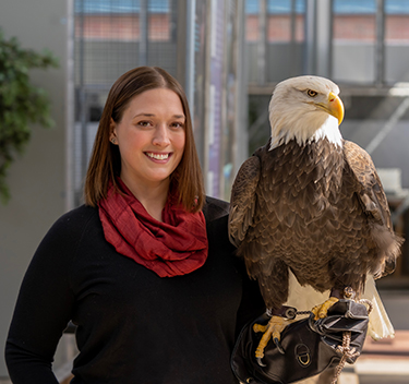 Portrait of Victoria Hall holding an eagle