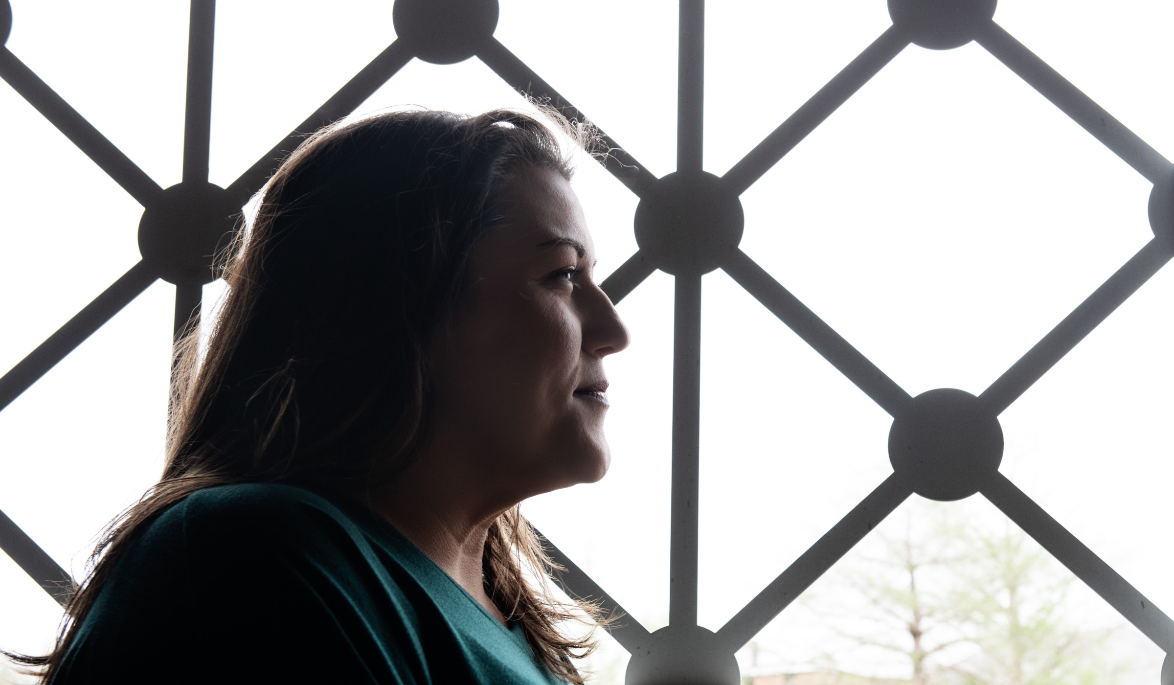 Emily Cain, pictured in front of a window on the MSU campus