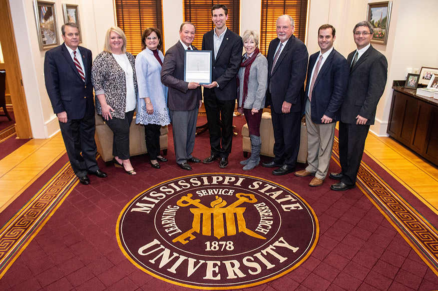 The Tennessee Valley Authority is recognizing Mississippi State with a 2018 Carbon Reduction Award for improving energy efficiency and reducing carbon emissions. Served by Starkville Utilities, MSU has implemented efficiency measures saving over $55 million over the past decade in utility costs. Pictured, from left, are MSU Assistant Vice President for Campus Services George Davis, TVA Government Relations Manager Amy Tate, MSU Vice President for Campus Services Amy Tuck, MSU President Mark E. Keenum, TVA Customer Service Manager Josh Wooten, Starkville Mayor Lynn Spruill, Starkville Utilities General Manager Terry Kemp, Starkville Utilities Assistant Manager Jacob Forrester and MSU Associate Director of Engineering Services J.D. Hardy. (Photo by Logan Kirkland)