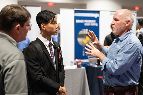 A student talks with an employer at MSU's Fall 2023 Career Expo.