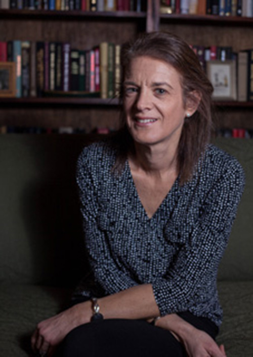 Portrait of Carolyn J. Brown sitting with bookshelves in the background