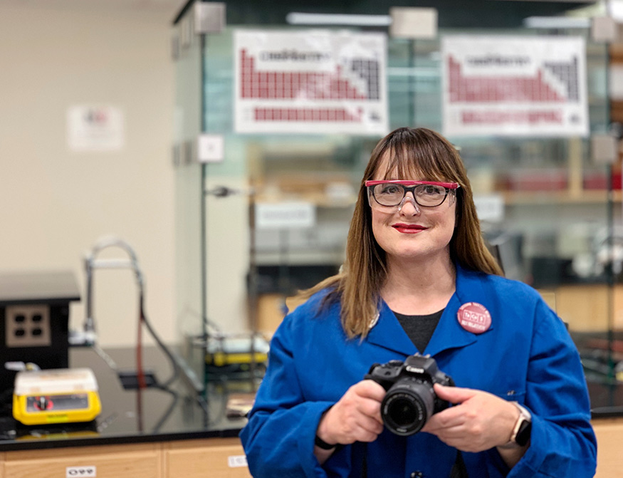 Teresa Brown, a Mississippi State lecturer and general chemistry lab coordinator, pictured in a lab setting and holding a camera.