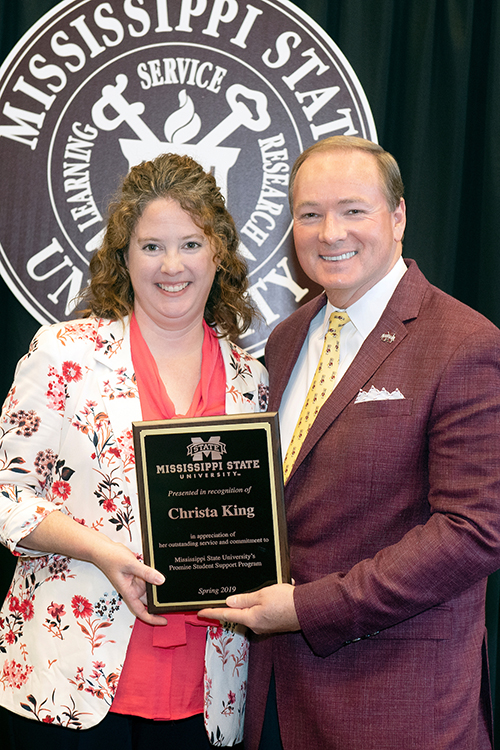 Christa King, a former instructor for MSU’s Program Program, receives a plaque for outstanding service and commitment from MSU President Mark E. Keenum during the program’s recent recognition ceremony. Though now working as project manager for the College of Education’s World Class Teaching Program, King continues to support Promise students in their academic journeys at MSU. (Photo by Beth Wynn)