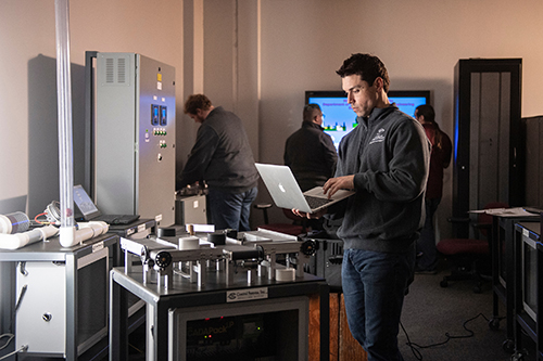 A young man works in a computer in a high-tech lab