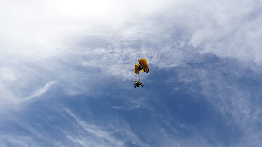 The skydivers prepare for a smooth landing. 