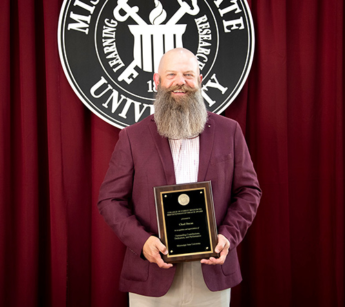 Chad Dacus holds the CFR/FWRC Extension/Outreach Award