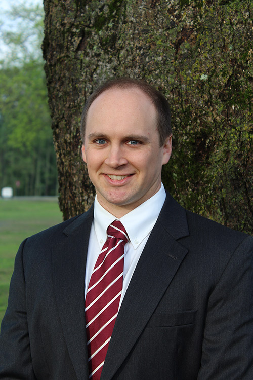 Portrait of Dave Spencer standing in front of a tree