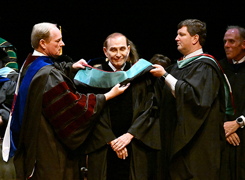 Martin Davidson of Meridian, center, is hooded by MSU President Mark E. Keenum, left, and Vice President for Development and Alumni John Rush during commencement at MSU-Meridian on Thursday [May 9]. The local entrepreneur and philanthropist received the Meridian campus’s first honorary Doctor of Public Service degree. (Photo by Marianne Todd)