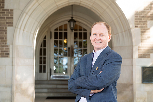 Angus Dawe, professor and head of MSU’s Department of Biological Sciences, is pictured in front of Harned Hall. 