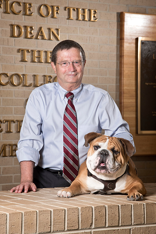 Mississippi State University College of Veterinary Medicine Dean Kent Hoblet is pictured with MSU Mascot Bully XXI, commonly referred to as “Jak.” (Photo by Tom Thompson)