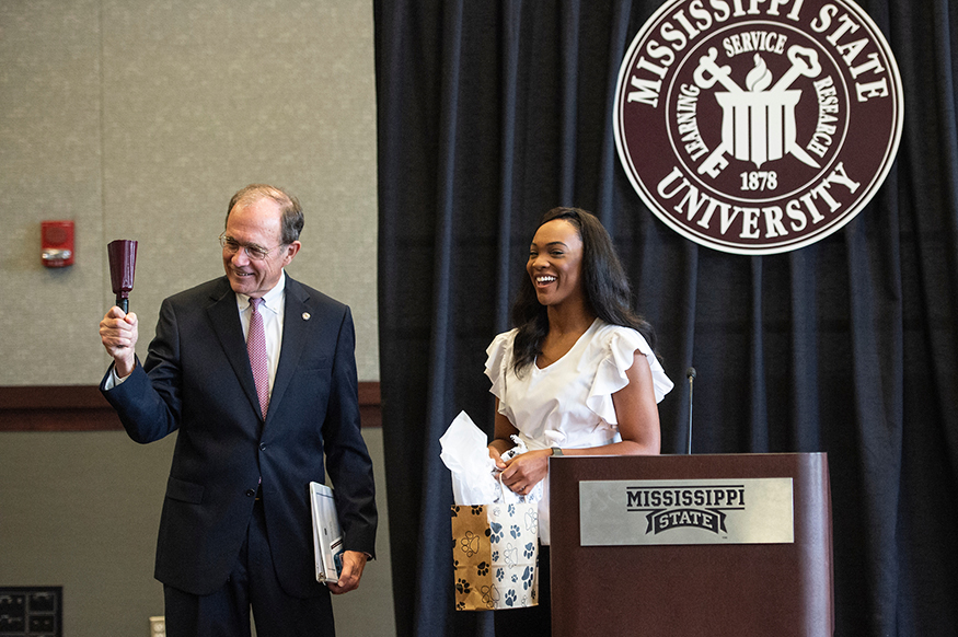 MSU Student Association President Mayah Emerson presents Mississippi Secretary of State Delbert Hosemann with a cowbell following Hosemann’s speech at MSU, where he encouraged students to register to vote. (Photo by Logan Kirkland)