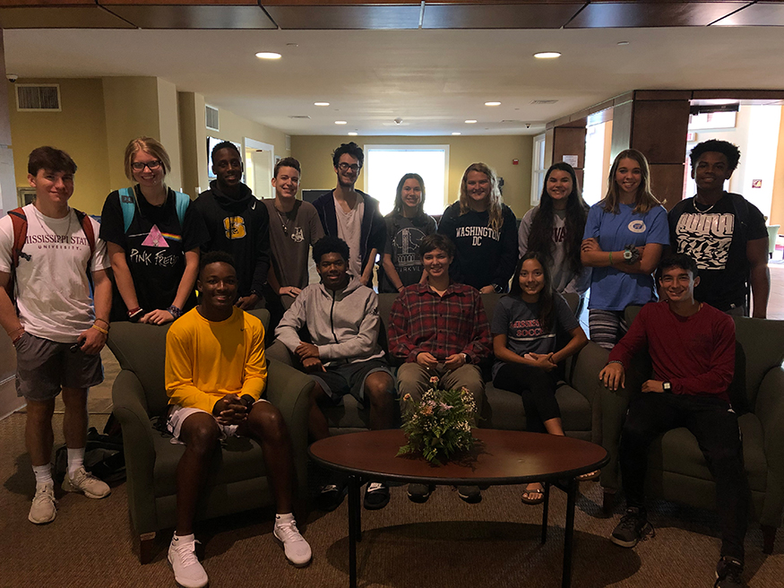 Starkville High School students smile for a group photo in the Griffis Hall lobby.