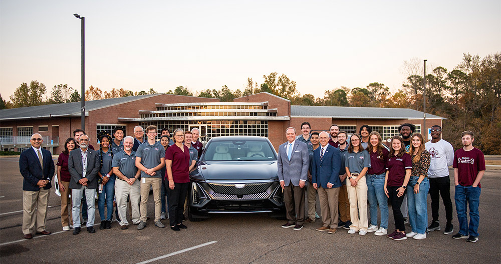 MSU President Mark E. Keenum and Provost David Shaw, center right, along with Vice President for Research and Economic Development Julie Jorden, left of car, are pictured with MSU’s student EcoCAR Electric Vehicle Challenge team members, along with faculty advisors who will help guide the team during the prominent four-year competition to implement an all-electric powertrain and other cutting-edge features in a new Cadillac LYRIQ. 