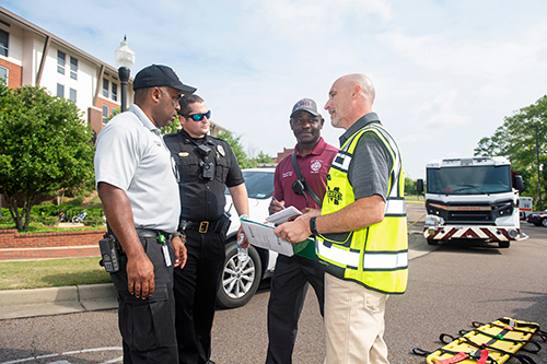 Responding to a hypothetical emergency scenario during a spring MSU preparedness exercise are, from left, OCH Regional Medical Center EMS Supervisor Shedrick Hogan; MSU Police Sergeant Nick Coe; Starkville Fire Department Battalion Chief Roosevelt Harris; and MSU Crisis Action Team Representative and On-Scene Controller Brian Locke. The university prioritizes preparedness and makes regular training a top priority.