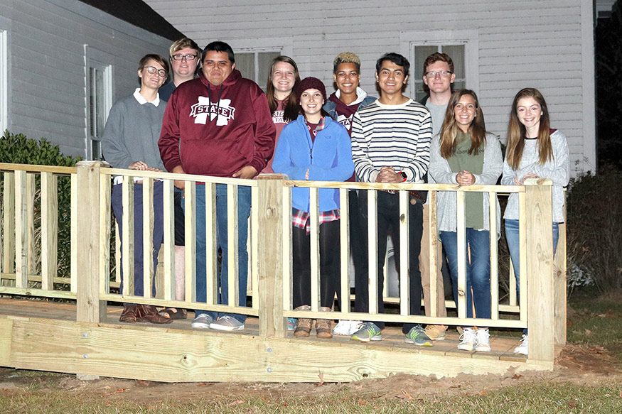 Freedom by Design workers are pictured on the completed ramp at Oktoc Community Club. Pictured, left to right, are Emily Turner, Alex Boyd, Pablo Vargas, Kaitlyn Breland, Bre Richeson, Mariah Green, Jose Solorzano, Jake Haasl, Kenzie Johnson and Ashley Casteel. (Photo submitted/Ashley Casteel)