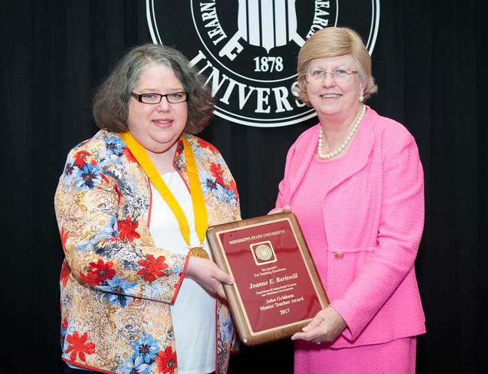 Mississippi State Assistant Professor Joanne E. Beriswill of MSU’s Department of Instructional Systems and Workforce Development, left, officially was designated a John Grisham Master Teacher during the university’s recent Faculty Awards and Recognition Reception. Congratulating Beriswill is MSU Provost and Executive Vice President Judy Bonner. (Photo by Russ Houston)