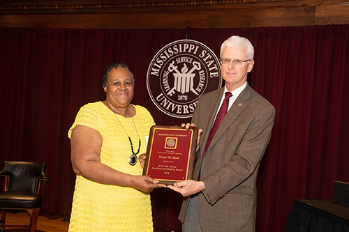 Peter Ryan, MSU associate provost for academic affairs, congratulates Vergie Bash, staff recipient of the Irvin Atly Jefcoat Excellence in Advising Award. (Photo by Beth Wynn)