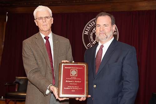 Peter Ryan, MSU associate provost for academic affairs, congratulates Richard Harkess, faculty recipient of the Irvin Atly Jefcoat Excellence in Advising Award. (Photo by Beth Wynn)