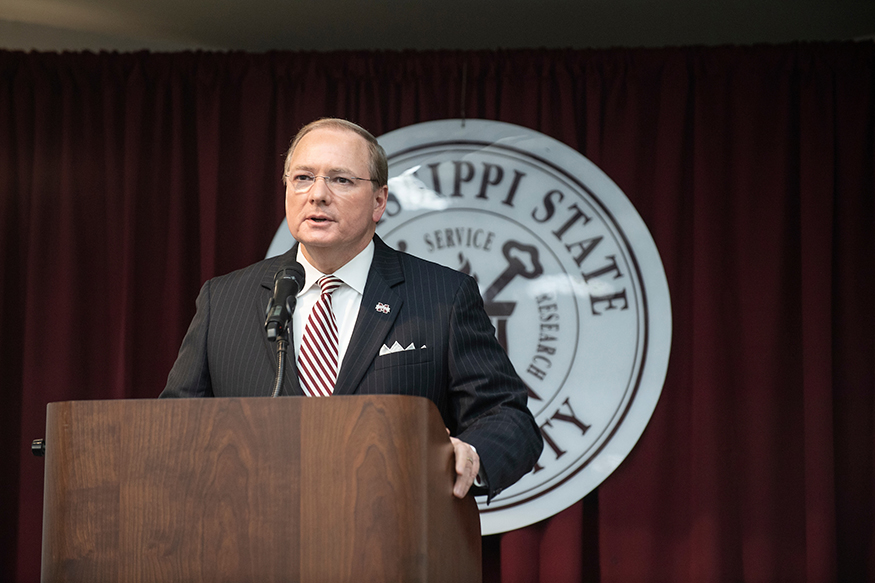 Mark E. Keenum speaks from a podium at the General Faculty Meeting.