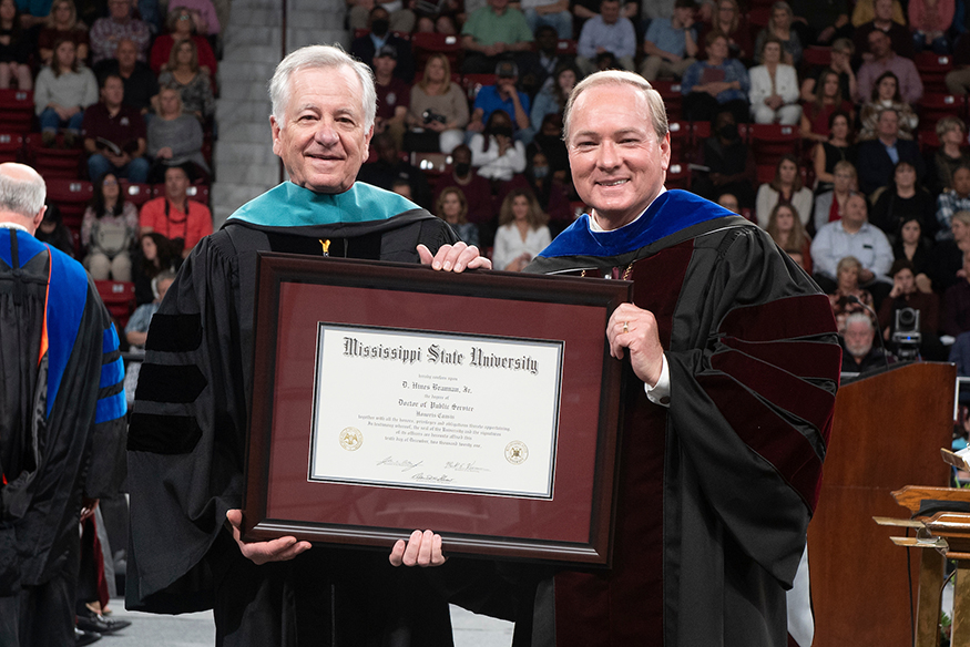 Mississippi State alumnus Hines Brannan, left, receives an honorary Doctor of Public Service degree from MSU President Mark E. Keenum, right, during Starkville’s Friday [Dec. 10] afternoon commencement ceremony in Humphrey Coliseum.