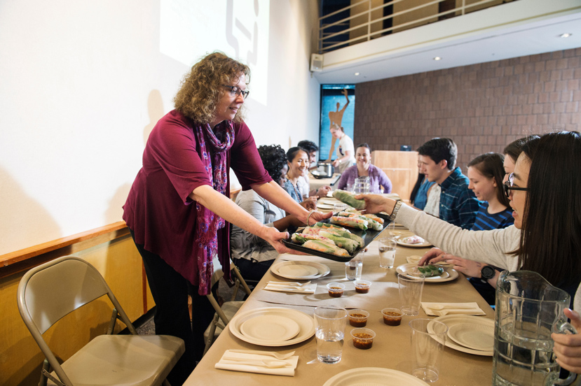 Renée Matich serves a rice dish to students during a “Sharing Experience: Heritage, Home and History” workshop recently held at Mississippi State University. She was an organizer of the multi-cultural, interdisciplinary project that included meals featuring rice, maize and wheat dishes. (Photo by Megan Bean)