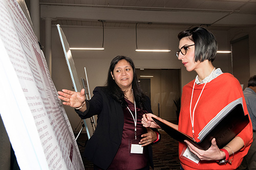Cecilia Brooks, a Mississippi State University human development and family science doctoral student from El Paso, Texas, explains her research to MSU Assistant Professor of Political Science and Public Administration Thessalia Merivaki during the recent Graduate Student Research Symposium. (Photo by Beth Wynn)