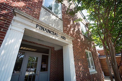 Garner Hall, home of MSU's Office of Financial Aid, is pictured-a brick building with a crepe myrtle beside the door.